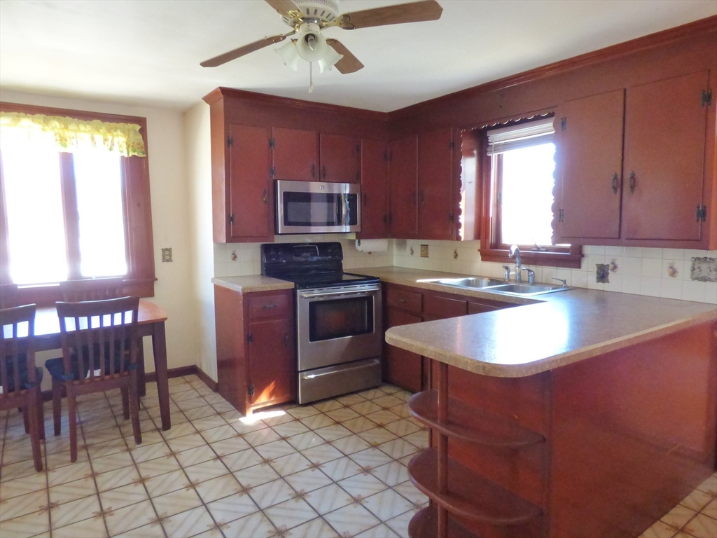 259 Prospect Street Ludlow, MA 01056 - Photo 6 of 30 a kitchen with stainless steel appliances granite countertop a sink stove and cabinets