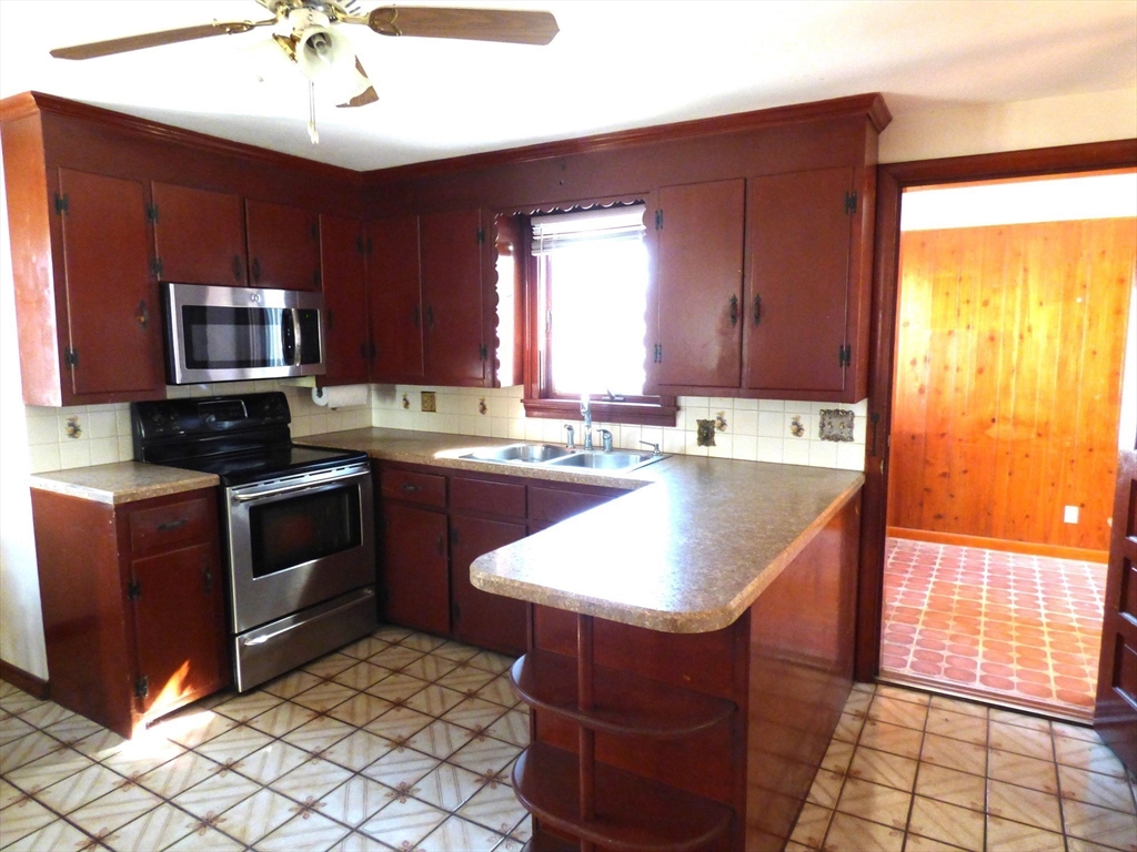 259 Prospect Street Ludlow, MA 01056 - Photo 9 of 30 a kitchen with stainless steel appliances granite countertop a sink stove and refrigerator