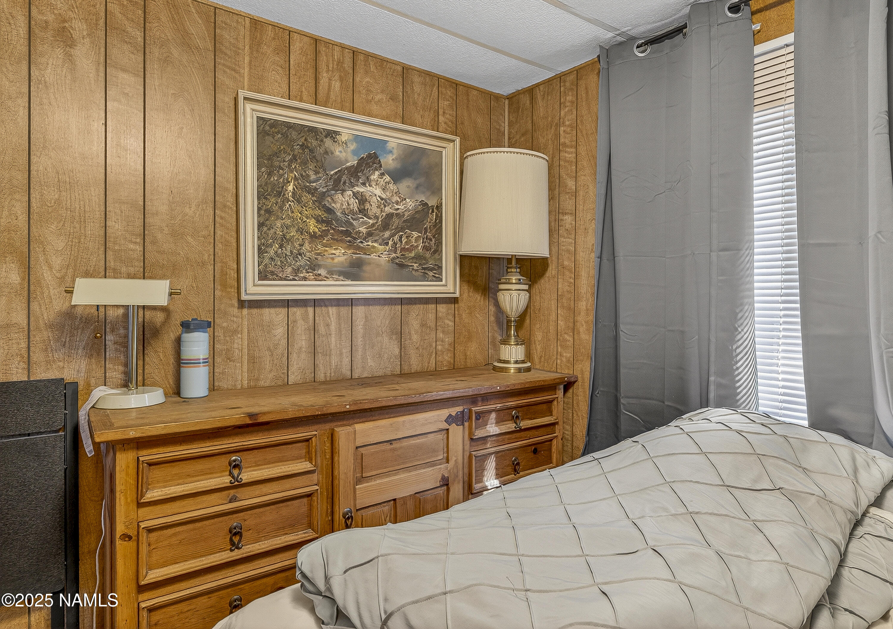 2500 West Rte 66, Unit 83 Flagstaff, AZ 86001 - Photo 12 of 24 a bedroom with a bed and a dresser with mirror
