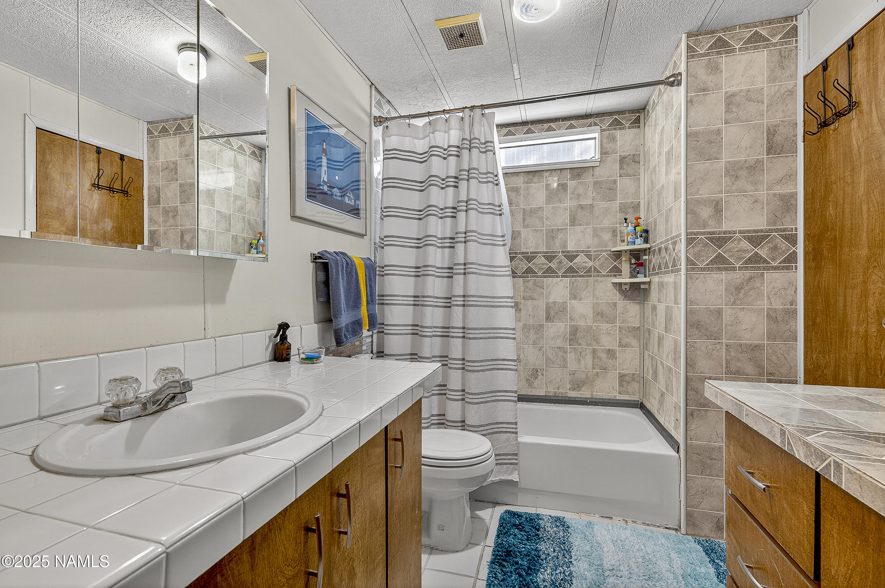 2500 West Rte 66, Unit 83 Flagstaff, AZ 86001 - Photo 13 of 24 a bathroom with a sink a toilet and bathtub