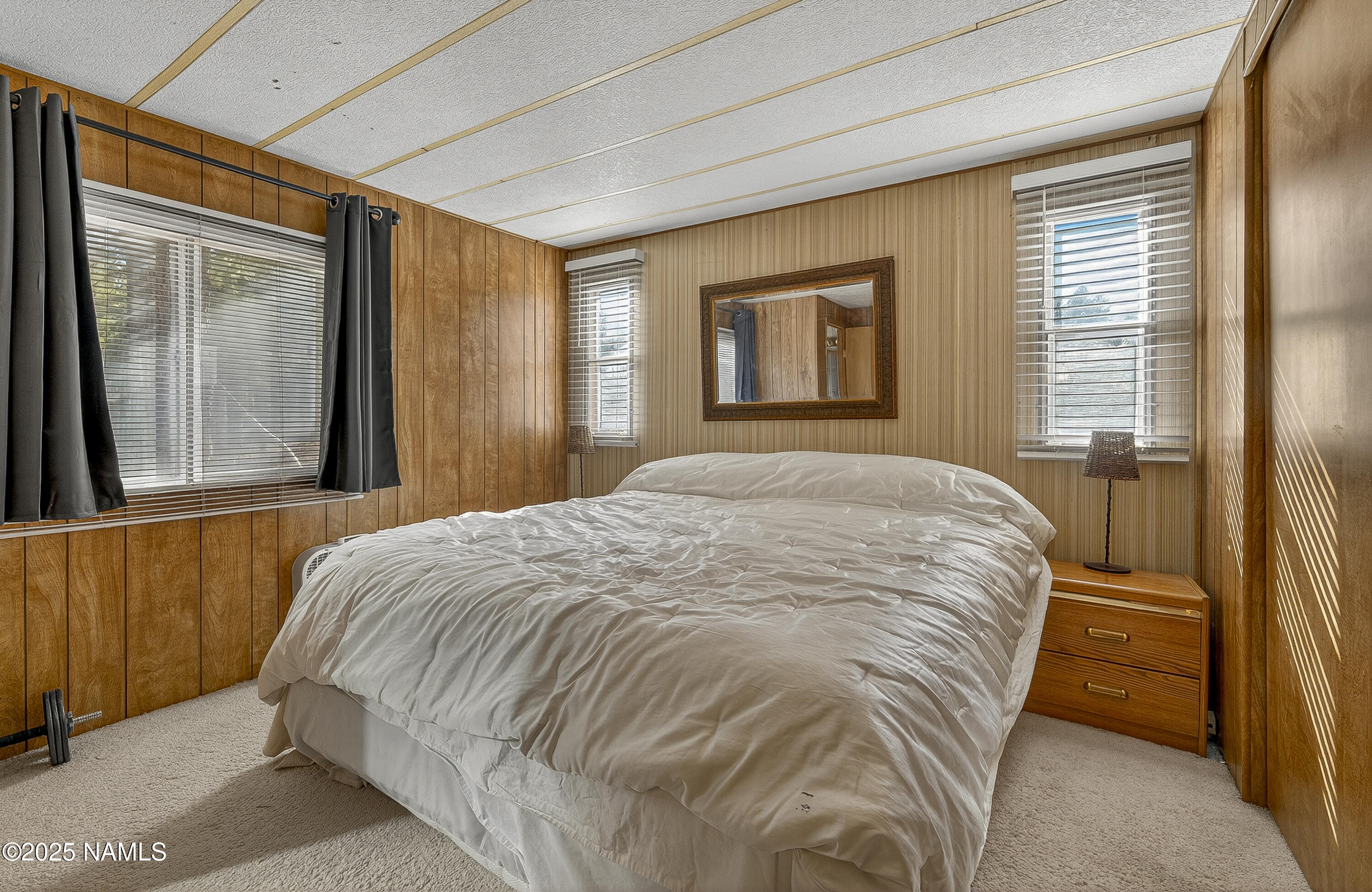 2500 West Rte 66, Unit 83 Flagstaff, AZ 86001 - Photo 14 of 24 a bed sitting in a bedroom next to a window