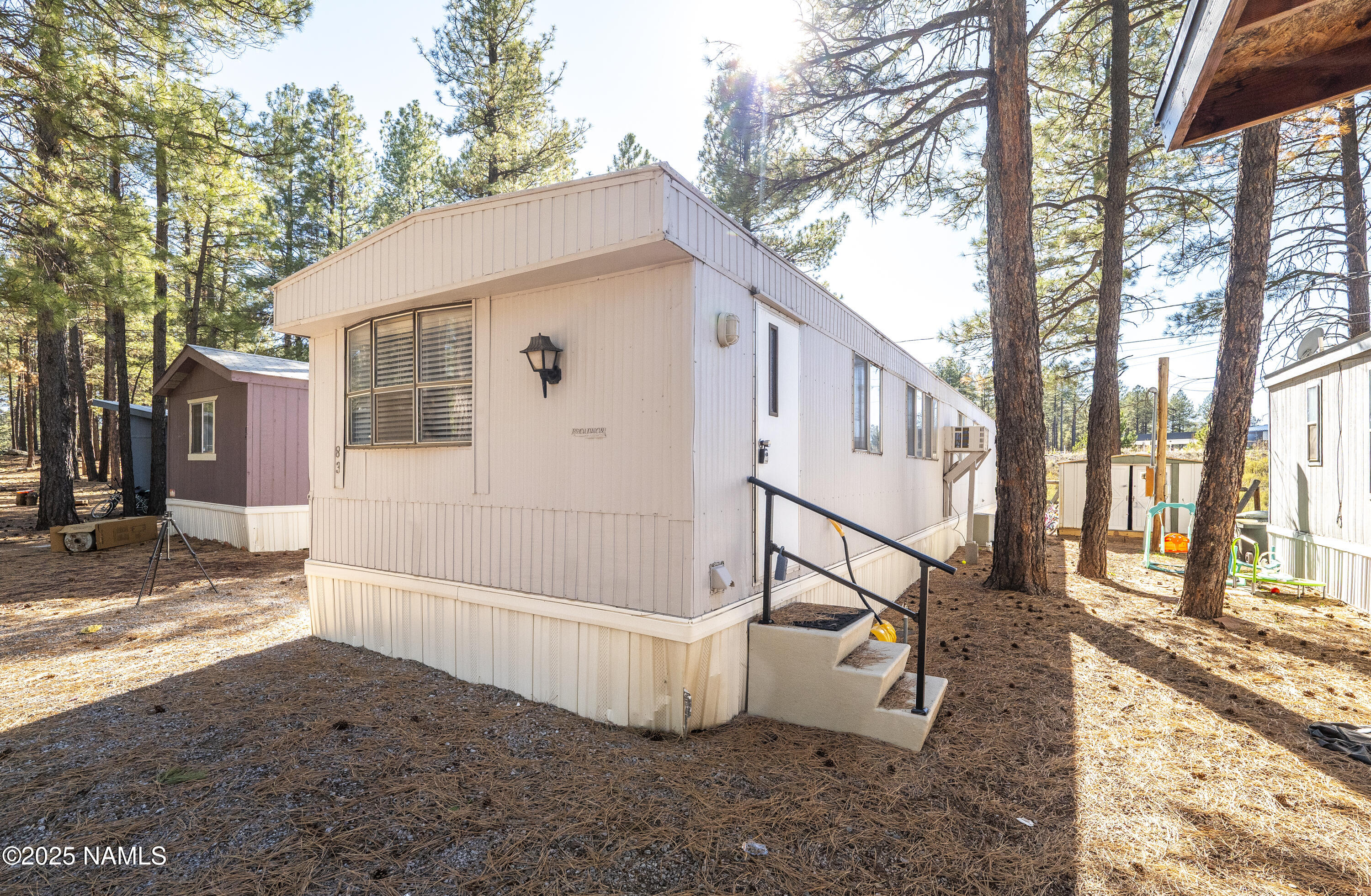 2500 West Rte 66, Unit 83 Flagstaff, AZ 86001 - Photo 19 of 24 a view of a house with a yard