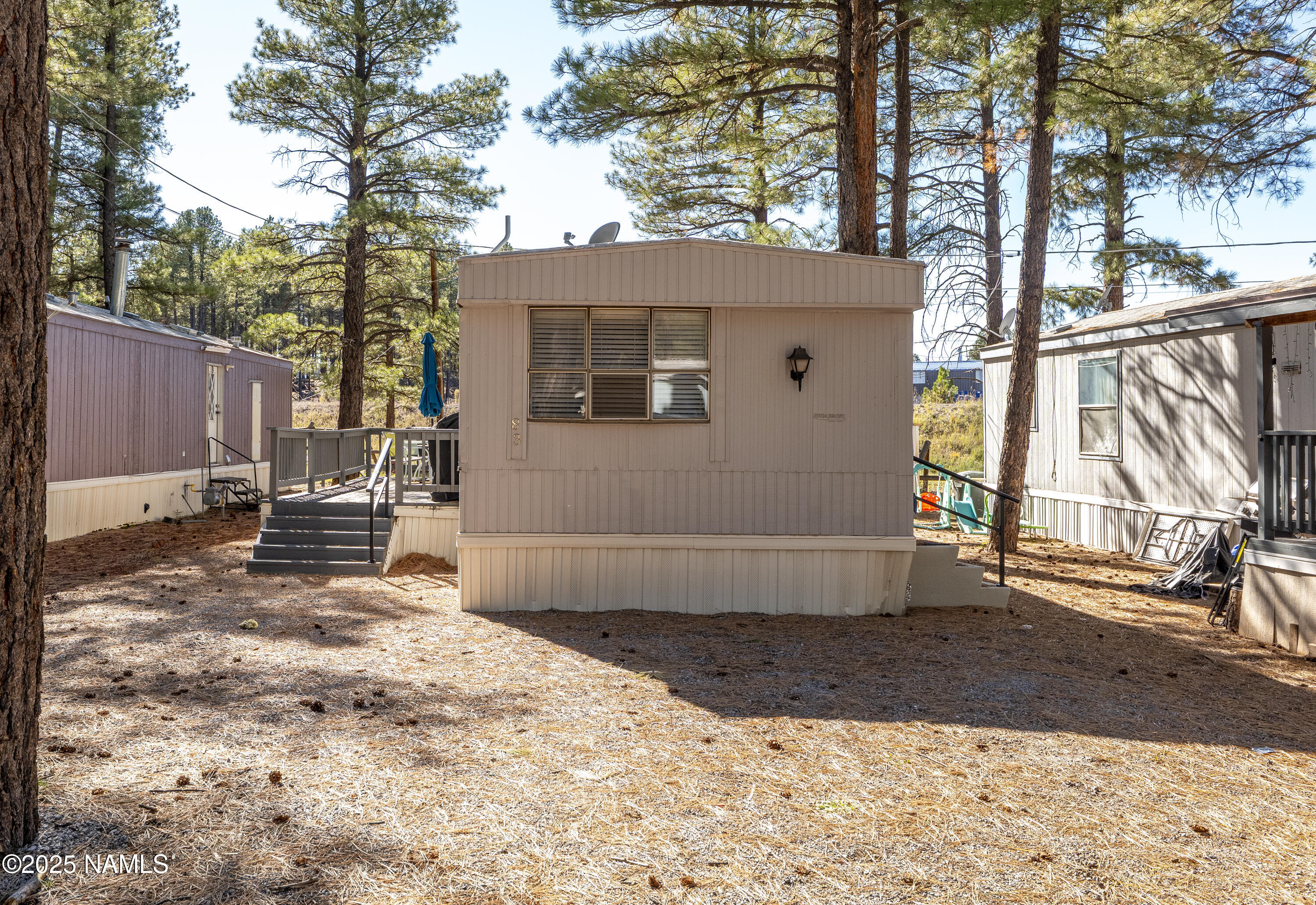 2500 West Rte 66, Unit 83 Flagstaff, AZ 86001 - Photo 3 of 24 a view of a house with a yard covered in snow