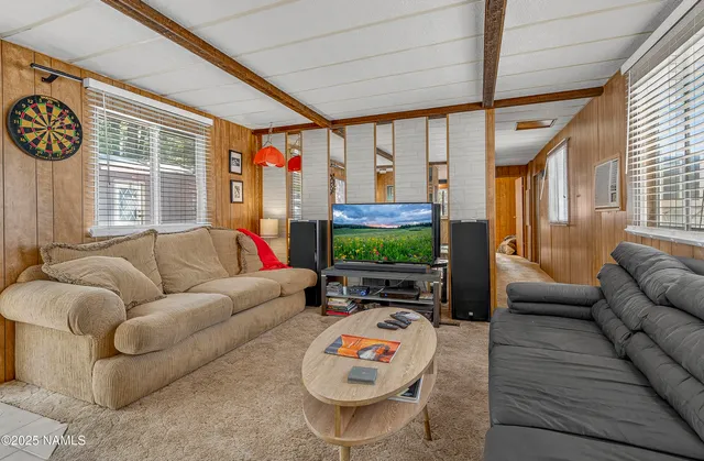 a living room with furniture a fireplace and a flat screen tv