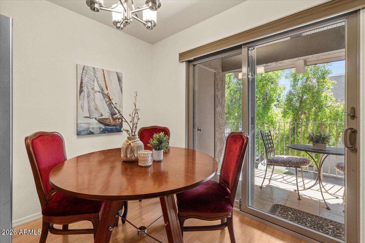 5525 East Thomas Road, Unit O12 Phoenix, AZ 85018 - Photo 6 of 27 a dining room with furniture a chandelier and window