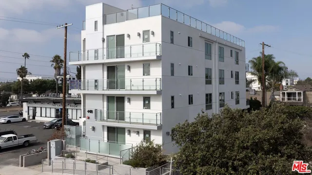 a view of multiple houses with a street