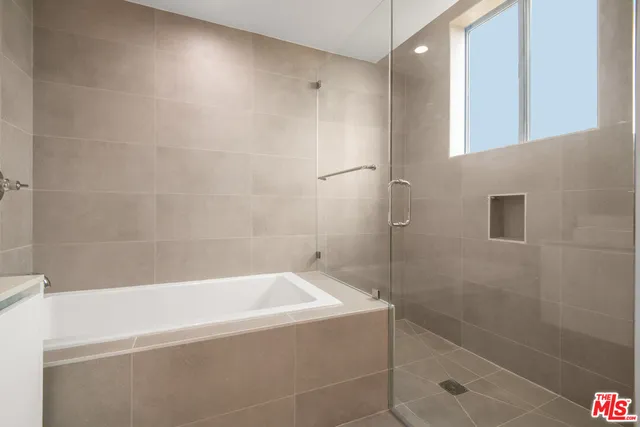 a bathroom with a bathtub and a shower