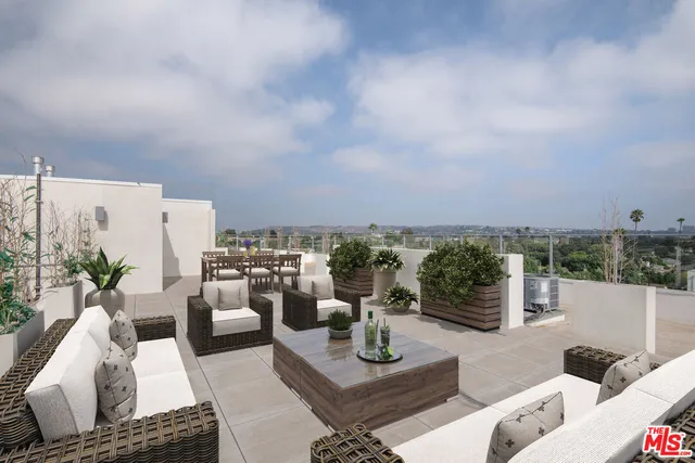 a view of a terrace with couches and potted plants