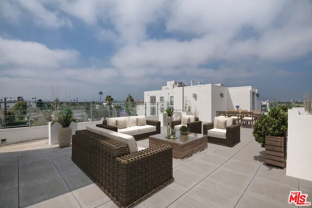 a view of a terrace with couches and potted plants
