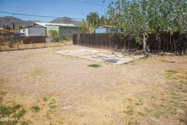 a view of a dining room with furniture a chandelier and wooden floor