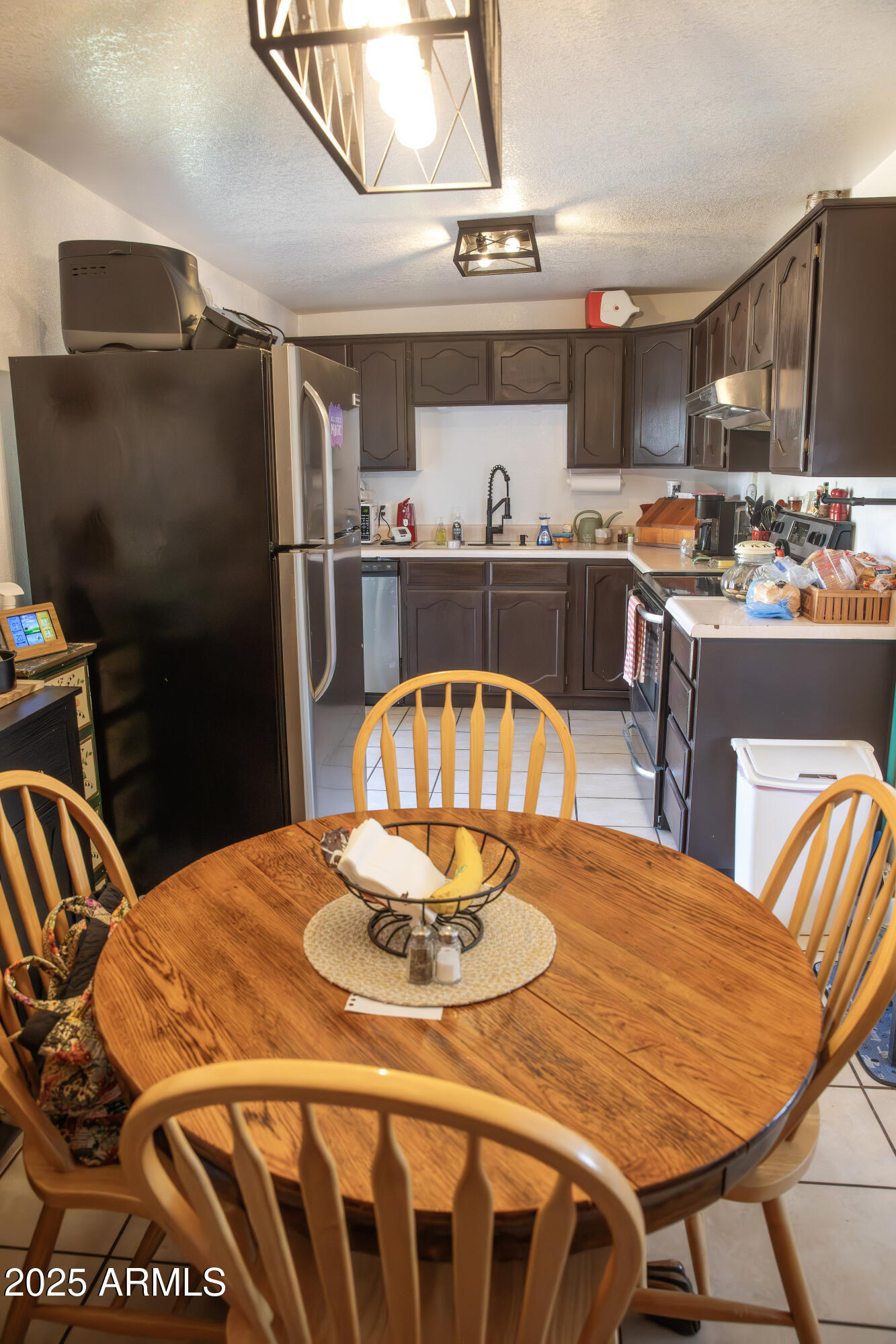 108 Graham Drive Bisbee, AZ 85603 - Photo 25 of 52 a kitchen with stainless steel appliances kitchen island granite countertop a dining table and chairs