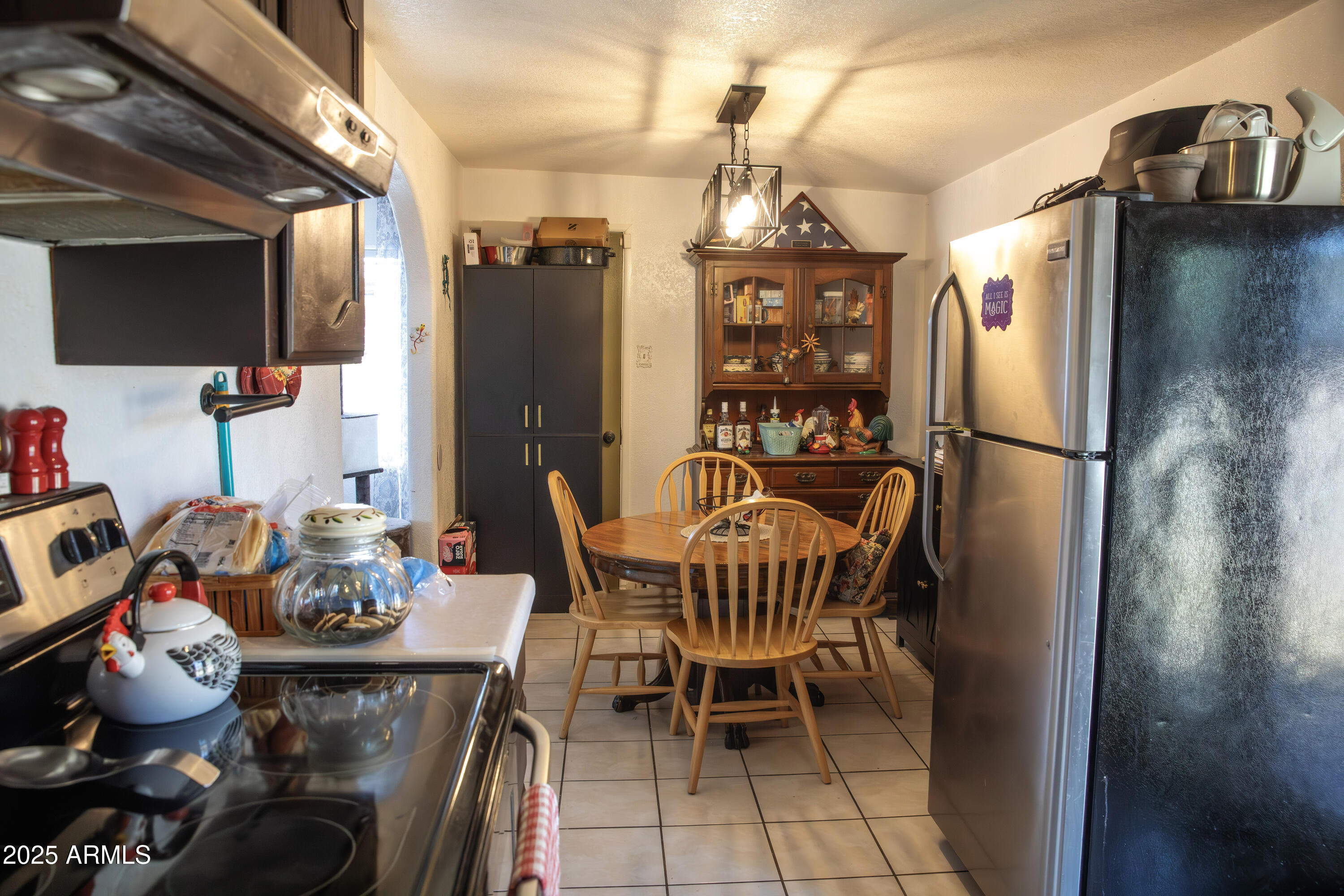 108 Graham Drive Bisbee, AZ 85603 - Photo 26 of 52 a dining room with furniture wooden floor a chandelier