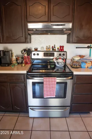 a kitchen with stainless steel appliances granite countertop a sink dishwasher and cabinets with wooden floor