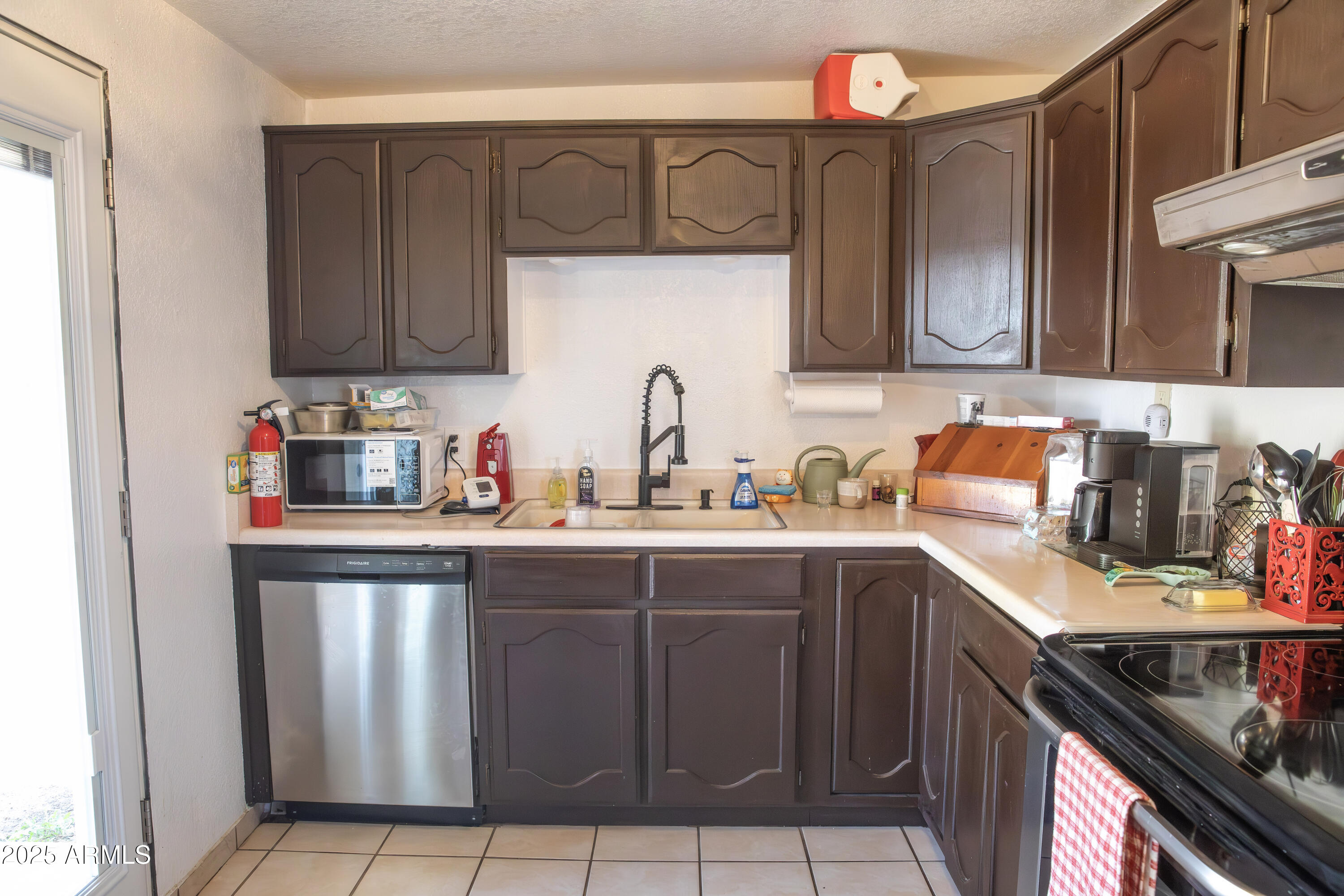 108 Graham Drive Bisbee, AZ 85603 - Photo 30 of 52 a kitchen with stainless steel appliances granite countertop a sink dishwasher and cabinets with wooden floor