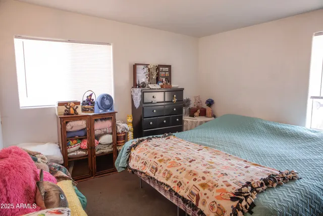 a bedroom with a bed and a dresser in it