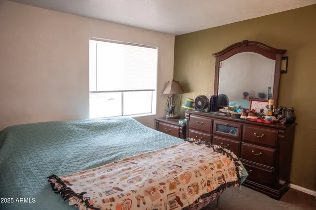 a bedroom with a bed and a window