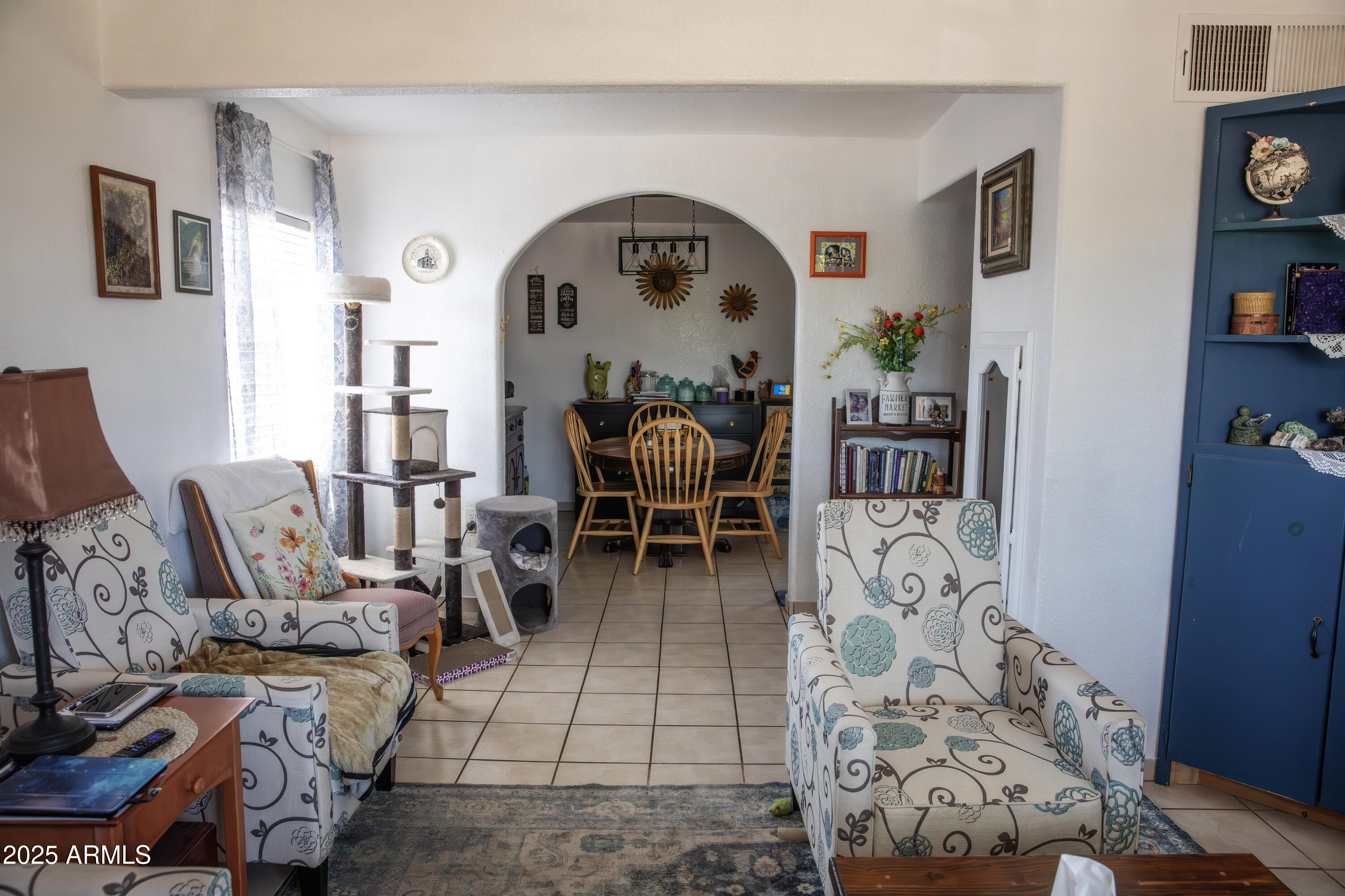 108 Graham Drive Bisbee, AZ 85603 - Photo 51 of 52 a living room with furniture and a bookshelf with wooden floor