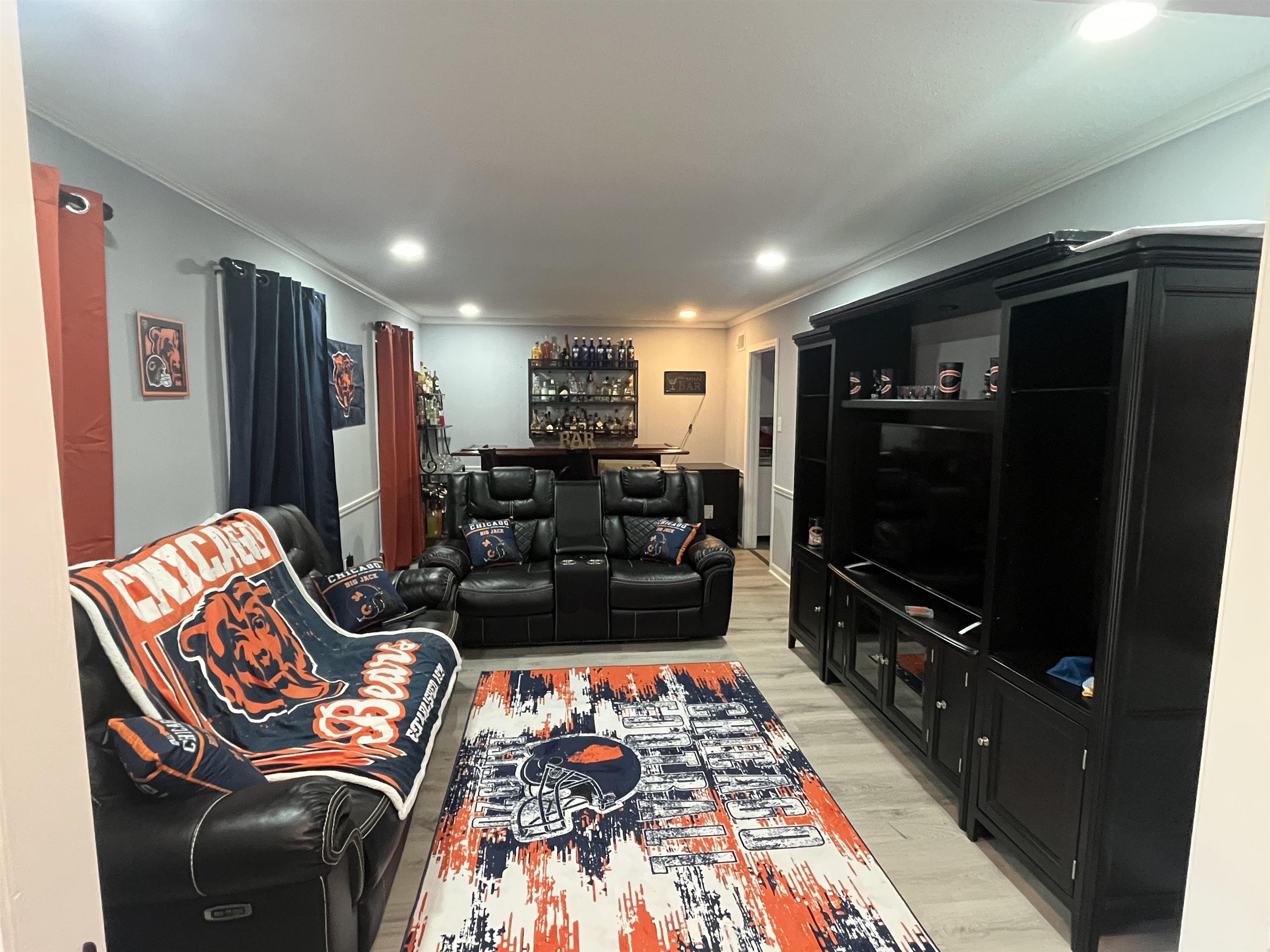 3010 Falkirk Road Memphis, TN 38128 - Photo 3 of 13 Living area featuring light wood-style flooring, crown molding, a bar, and recessed lighting