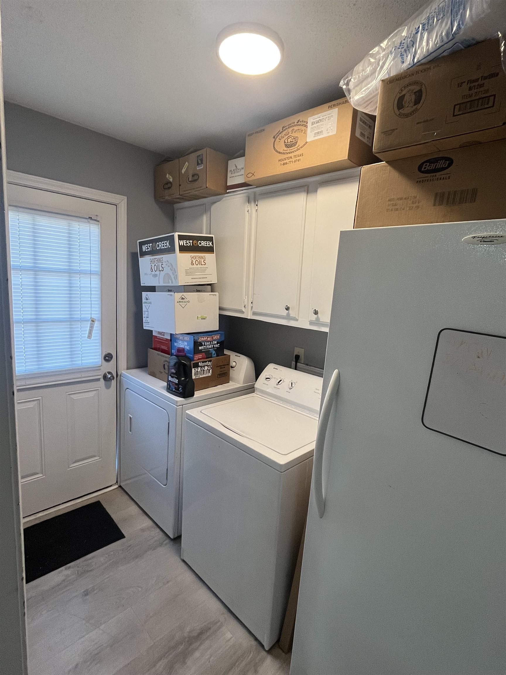 3010 Falkirk Road Memphis, TN 38128 - Photo 8 of 13 Washroom with light wood-type flooring, cabinet space, and washer and clothes dryer