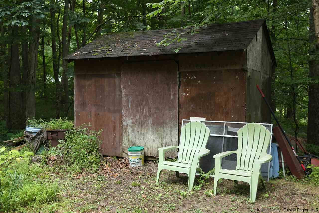 172 Bruceville Road High Falls, NY 12440 - Photo 8 of 10 a wooden bench sitting in backside of a house with a yard porch