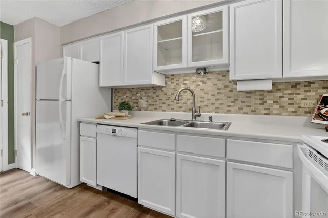 a kitchen with stainless steel appliances white cabinets and a sink