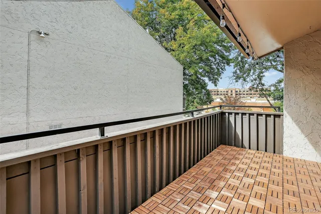 a balcony with wooden floor