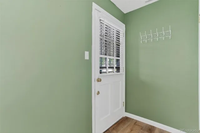 a view of front door with wooden floor