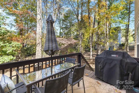 a view of a wooden chairs and table in the balcony