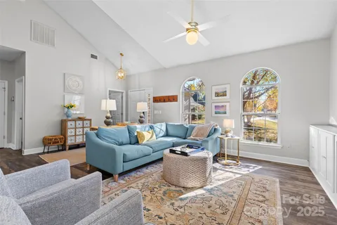 a living room with furniture a table and a window