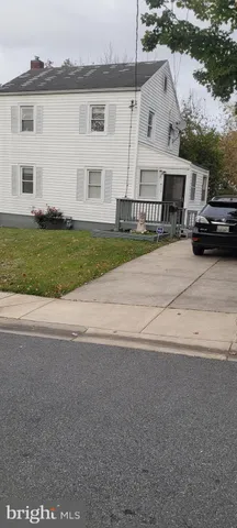 a front view of a house with a garden and yard