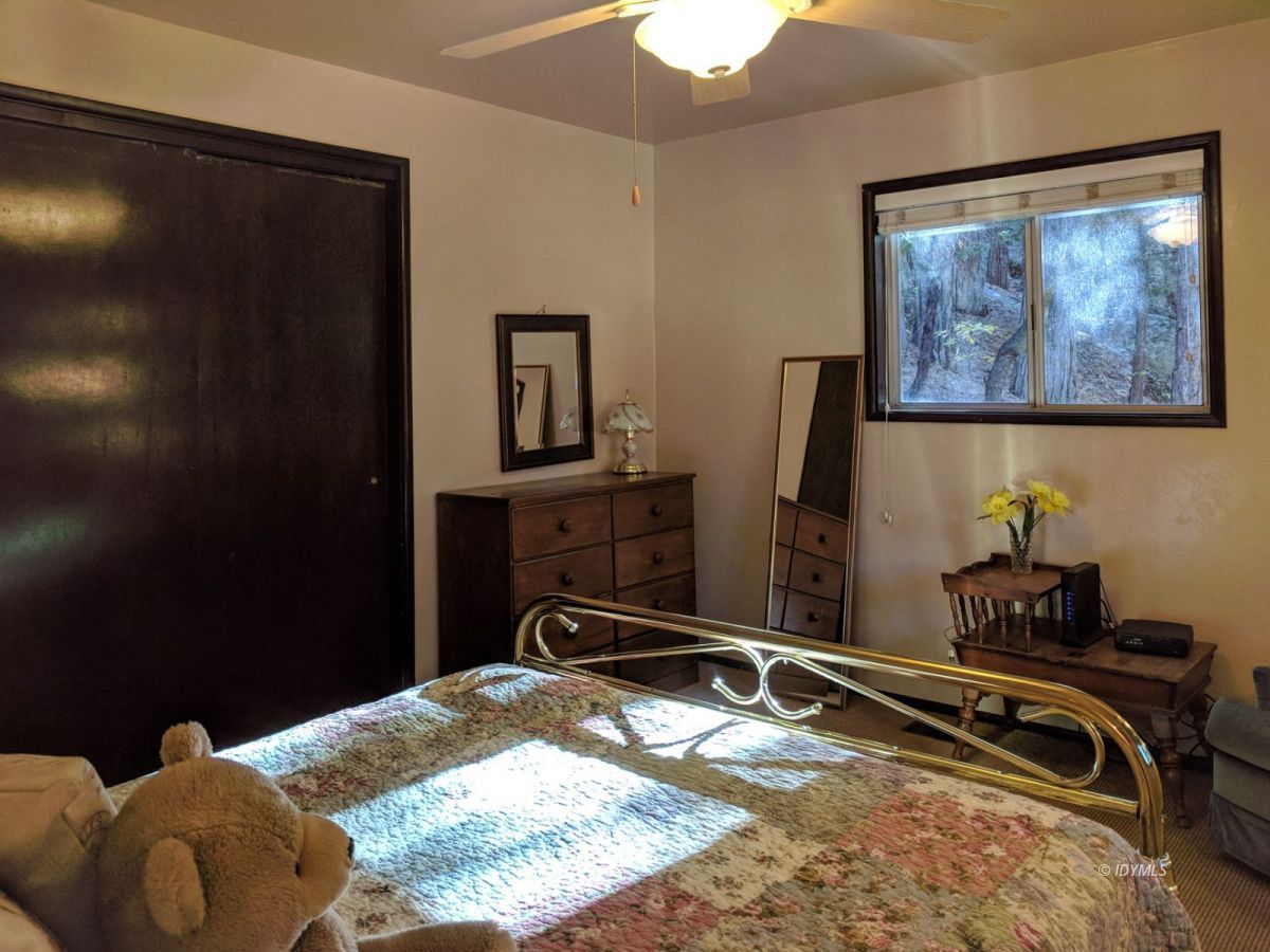 52550 Idyllmont Road Idyllwild, CA 92549 - Photo 32 of 73 a bedroom with a bed and a mirror