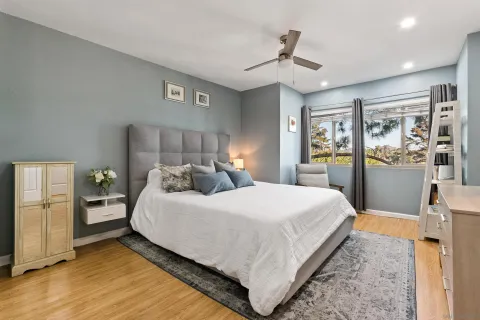 a bedroom with a large bed and a chandelier