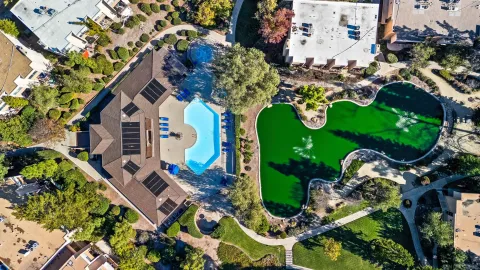 an aerial view of residential house with outdoor space and swimming pool