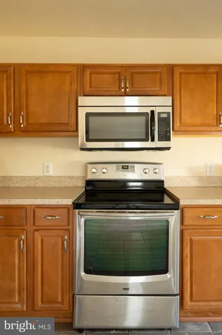 a stove top oven sitting inside of a kitchen