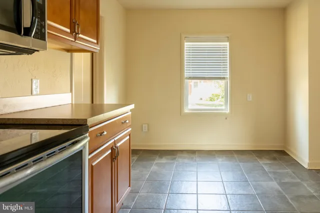 a kitchen with a stove a sink and a microwave