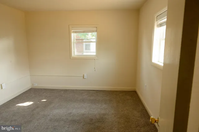 a view of a room with an empty space and a hallway