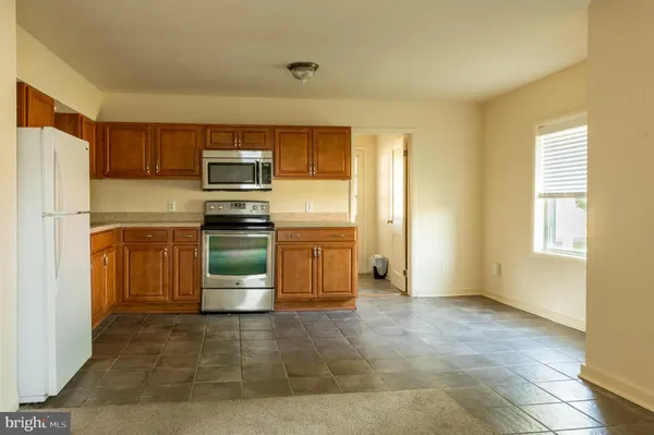 a kitchen with a refrigerator and a sink