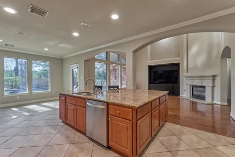 a kitchen with stainless steel appliances granite countertop a stove a sink and a refrigerator