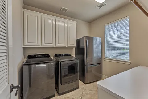 a kitchen with stainless steel appliances granite countertop a refrigerator a stove and a sink with wooden floor