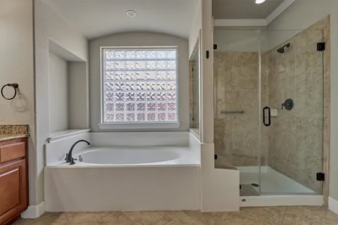 a white bath tub sitting next to a shower