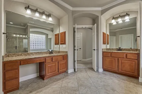 a large bathroom with a granite countertop double vanity and a mirror
