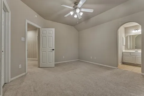 an empty room with chandelier fan