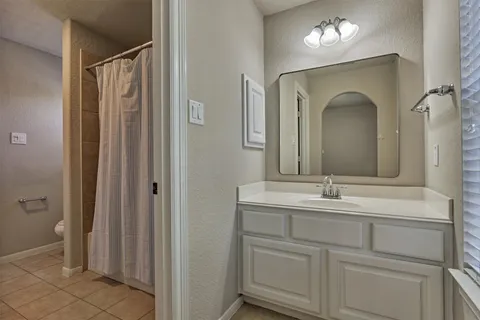 a bathroom with a double vanity sink and mirror