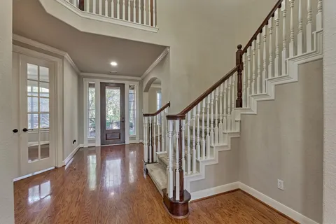 a view of entryway with wooden floor and stairs