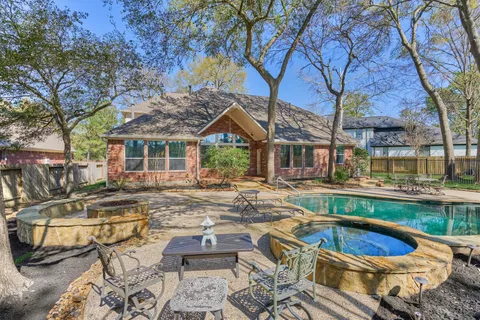 a view of a patio with swimming pool table and chairs
