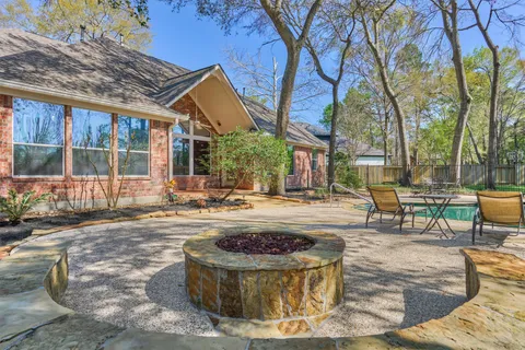 a view of a house with backyard and sitting area