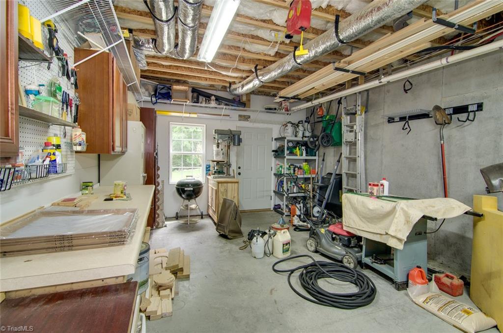 5032 Bennington Way High Point, NC 27262 - Photo 29 of 30 A man's dream - large workshop area in basement with outside entrance.