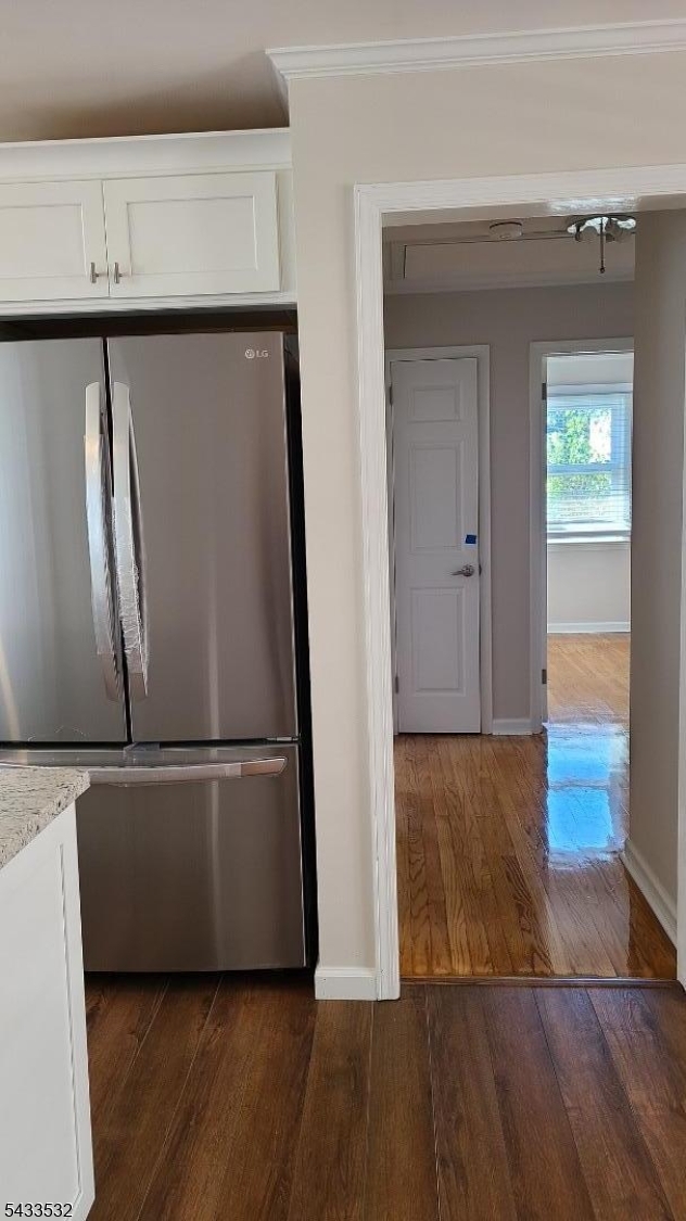 16 Ocean Street Millburn, NJ 07041 - Photo 17 of 26 a view of a refrigerator in kitchen and an empty room with wooden floor