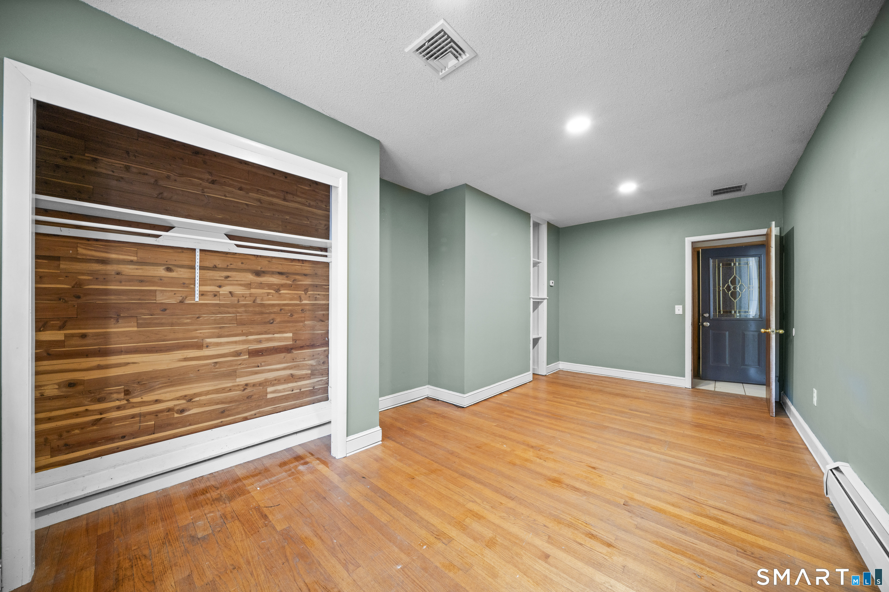 514 Hilliard Street Manchester, CT 06042 - Photo 19 of 38 a view of an empty room with wooden floor and a window