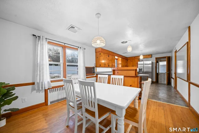 a view of a dining room with furniture window and wooden floor
